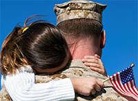 Man in uniform hugging girl